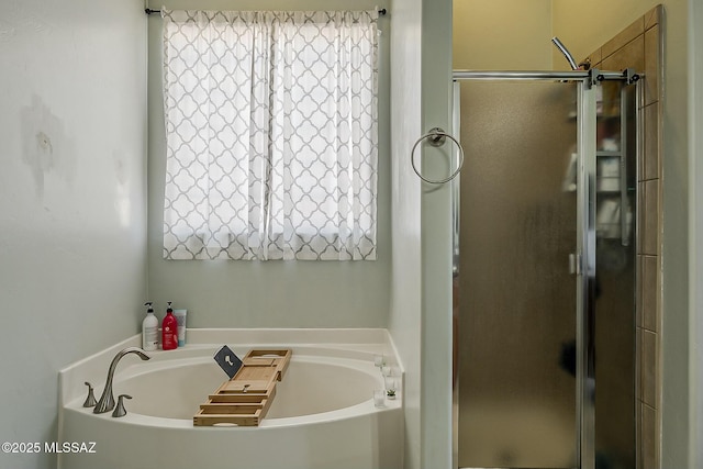 full bathroom featuring a garden tub and a stall shower