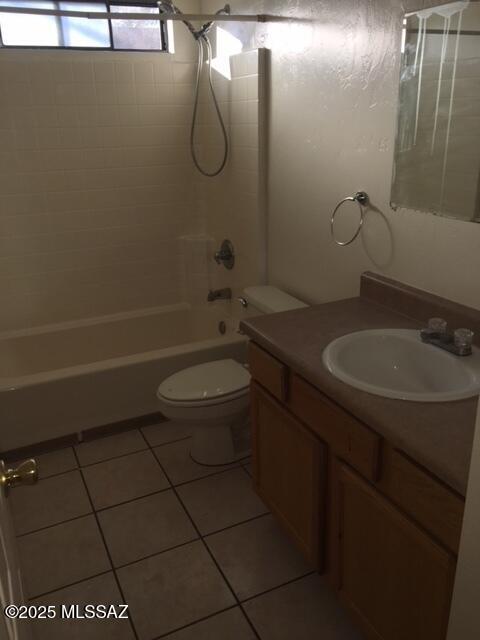 full bathroom featuring tile patterned floors, vanity, toilet, and bathing tub / shower combination