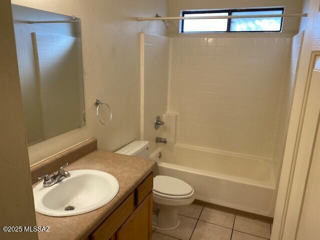 full bathroom with shower / bath combination, toilet, vanity, and tile patterned flooring