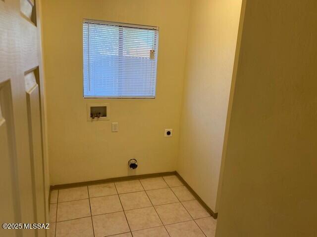 washroom with baseboards, laundry area, hookup for a washing machine, light tile patterned flooring, and electric dryer hookup
