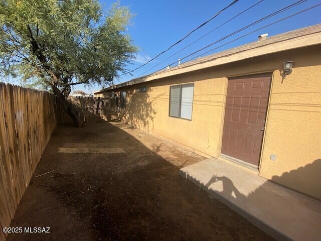 view of home's exterior featuring fence