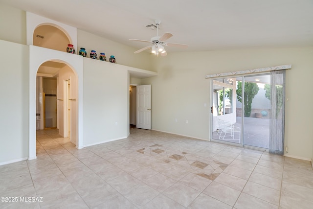 1181 W Placita Lucinda, Green Valley, AZ 85614 - spare room featuring baseboards, lofted ceiling, light tile patterned flooring, arched walkways, and ceiling fan