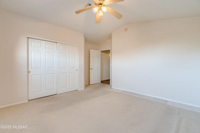 1181 W Placita Lucinda, Green Valley, AZ 85614 - unfurnished bedroom with visible vents, lofted ceiling, a closet, baseboards, and light colored carpet