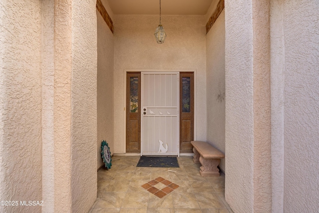 entrance to property featuring stucco siding