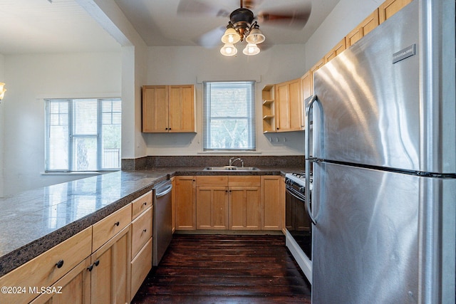 kitchen featuring light brown cabinets, tile counters, a wealth of natural light, appliances with stainless steel finishes, and a sink