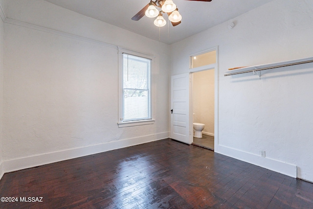 unfurnished bedroom featuring dark wood-type flooring, a ceiling fan, and baseboards