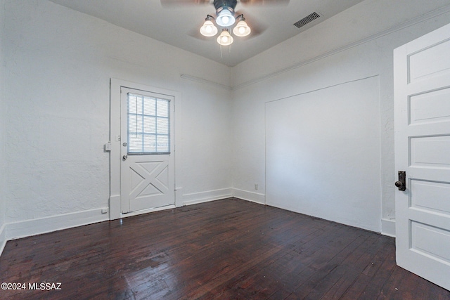 spare room with visible vents, baseboards, ceiling fan, and wood-type flooring