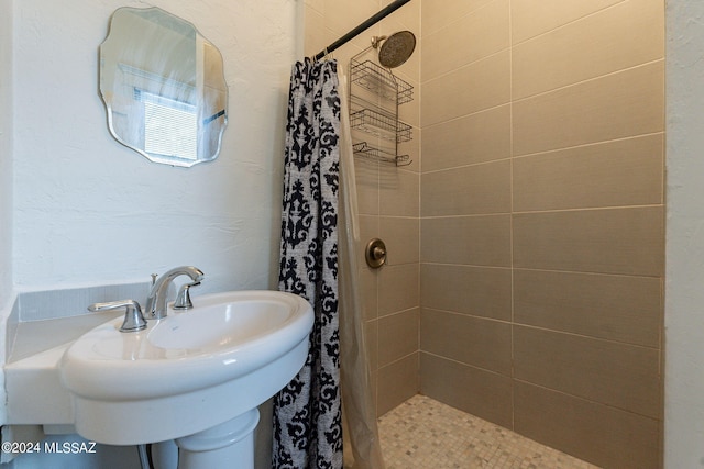 bathroom featuring a sink and a stall shower