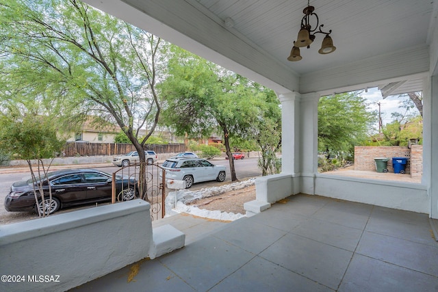 view of patio / terrace featuring fence and covered porch