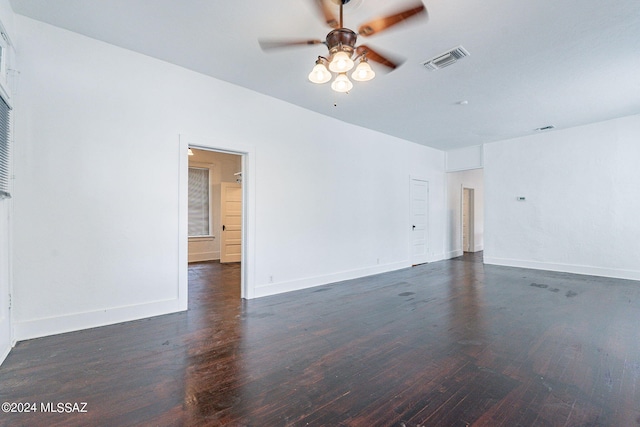 spare room with visible vents, ceiling fan, baseboards, and wood finished floors