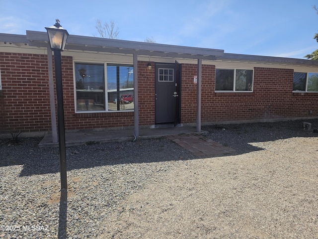 view of front of home featuring brick siding