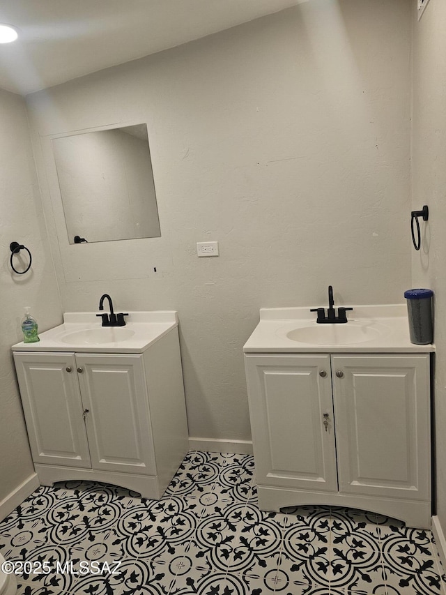 bathroom featuring baseboards, tile patterned flooring, and vanity