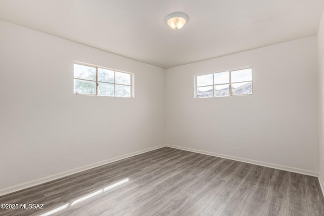 unfurnished room featuring wood finished floors and baseboards