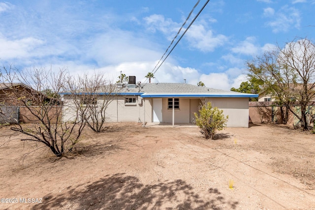 rear view of property with fence