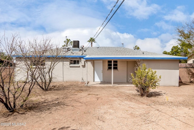 rear view of house featuring stucco siding and a patio