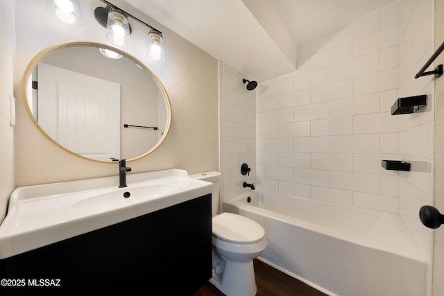bathroom featuring toilet, vanity, wood finished floors, and bathtub / shower combination