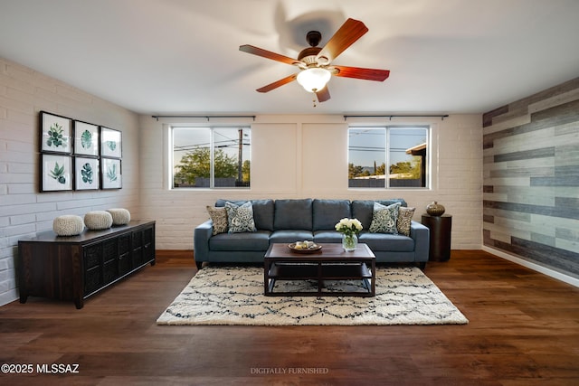 living room featuring a ceiling fan, wood finished floors, and baseboards