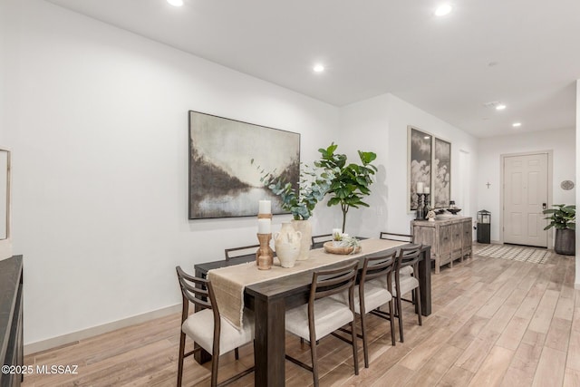 dining room featuring recessed lighting, baseboards, and light wood finished floors