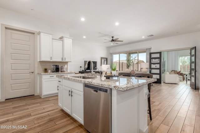 kitchen with dishwasher, light wood-style floors, and open floor plan