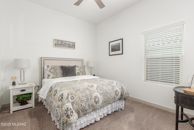 carpeted bedroom with a ceiling fan and baseboards