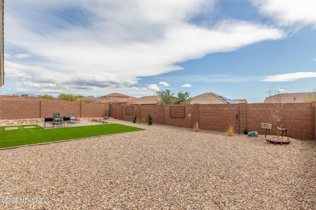 view of yard featuring a patio area and a fenced backyard