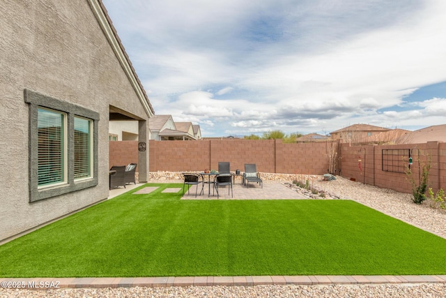 view of yard featuring a patio and a fenced backyard