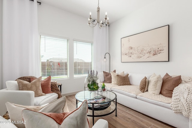 living area featuring an inviting chandelier and wood finished floors