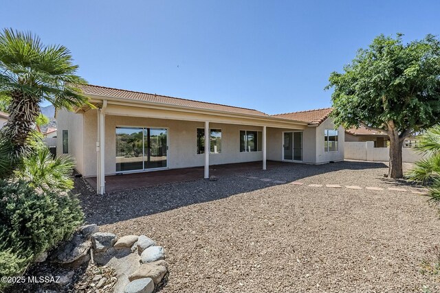 38034 S Golf Course Dr, Saddlebrooke, AZ 85739 - rear view of house featuring fence, a patio, a tiled roof, and stucco siding