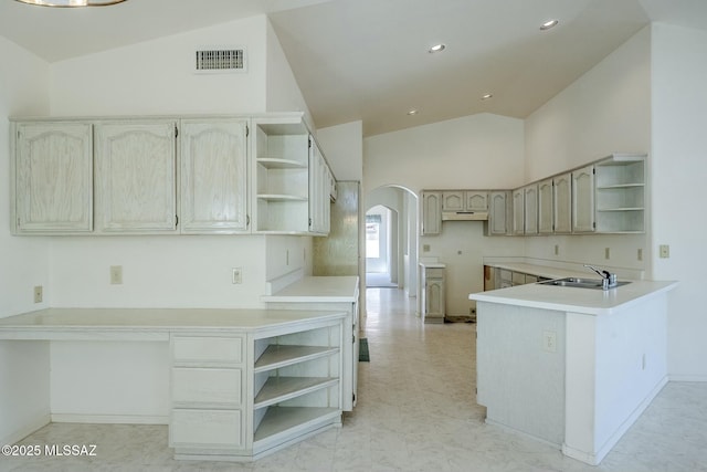 38034 S Golf Course Dr, Saddlebrooke, AZ 85739 - kitchen with a peninsula, arched walkways, a sink, visible vents, and open shelves