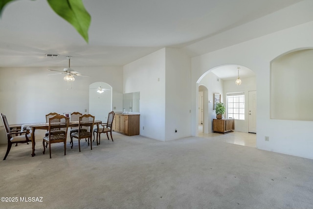 38034 S Golf Course Dr, Saddlebrooke, AZ 85739 - dining area with visible vents, light colored carpet, arched walkways, high vaulted ceiling, and ceiling fan