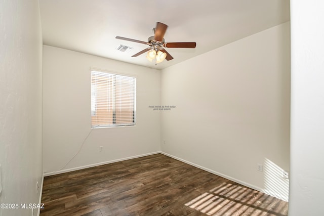 unfurnished room with visible vents, baseboards, dark wood-type flooring, and ceiling fan