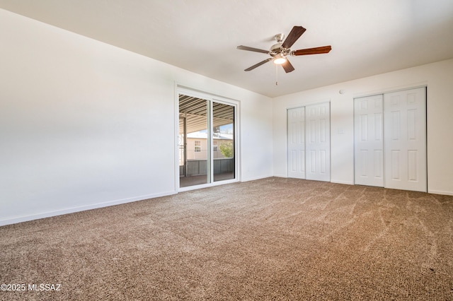 unfurnished bedroom featuring baseboards, two closets, carpet flooring, and access to outside