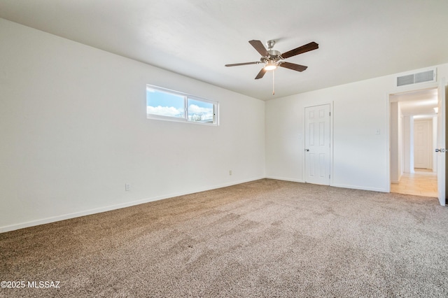 unfurnished bedroom with visible vents, carpet flooring, a ceiling fan, and baseboards