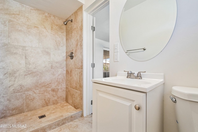 full bathroom with vanity, a shower stall, and toilet