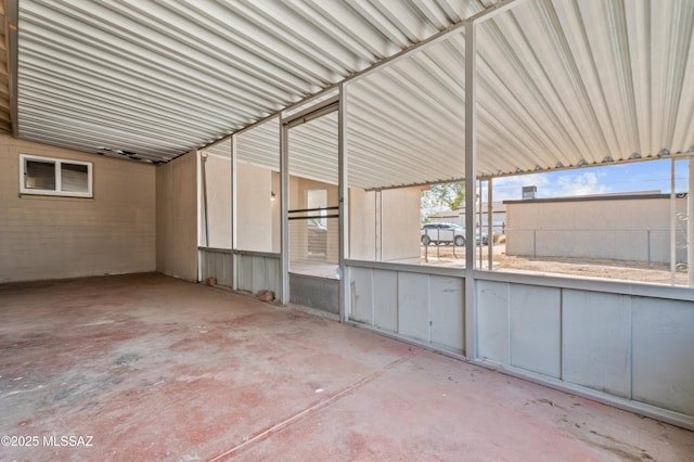 view of patio featuring an attached carport and fence