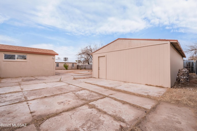 exterior space featuring an outdoor structure and fence