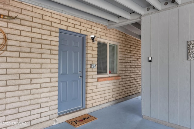 entrance to property with brick siding