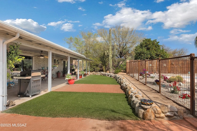 view of yard with a patio area, fence, and ceiling fan