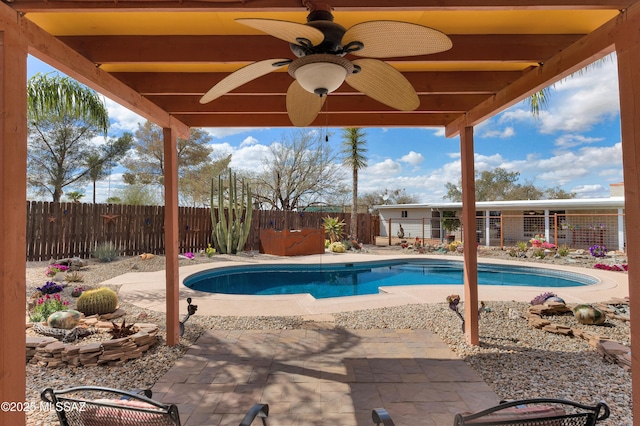 view of swimming pool with ceiling fan, a fenced in pool, a fenced backyard, and a patio area