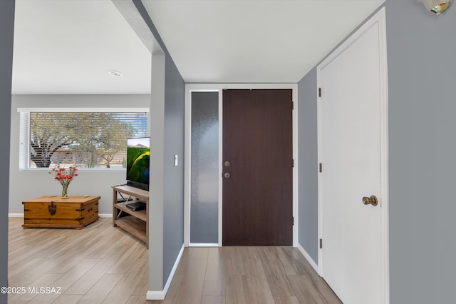 entrance foyer featuring wood finished floors and baseboards