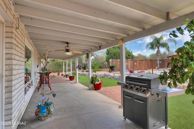 view of patio / terrace with area for grilling, a ceiling fan, and fence