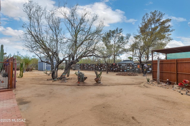 view of yard with an outbuilding and fence