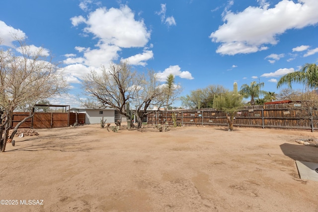 view of yard with an outbuilding and fence