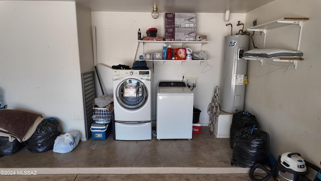 laundry area with laundry area, washing machine and dryer, and electric water heater