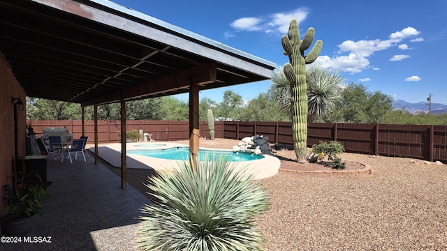 view of pool featuring a fenced in pool, a fenced backyard, and a patio area