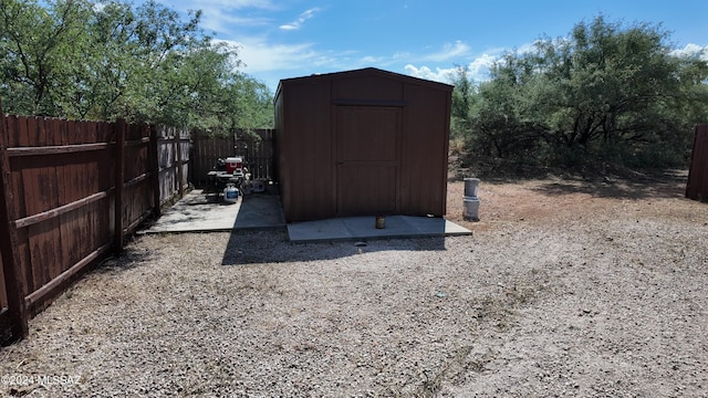 view of shed featuring fence private yard