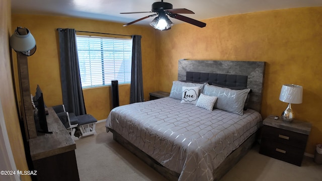 bedroom with a ceiling fan and carpet flooring