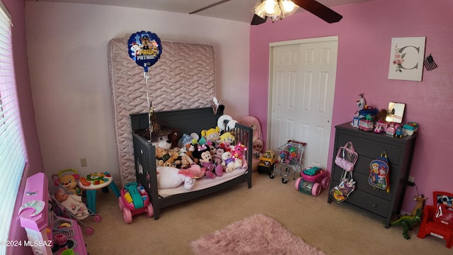 carpeted bedroom featuring a ceiling fan and a closet