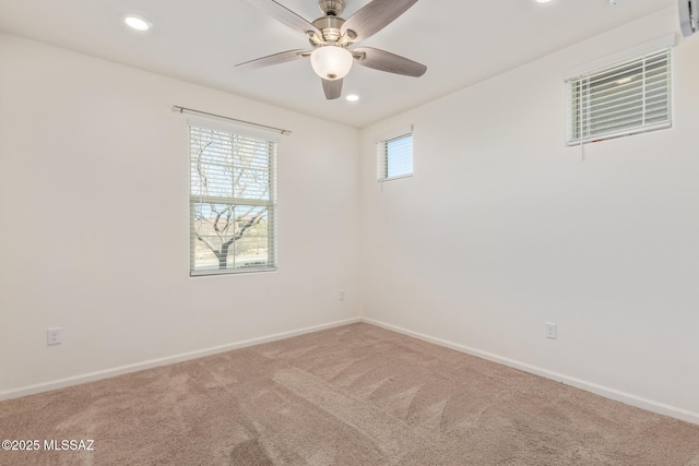 spare room featuring ceiling fan, carpet, baseboards, and a healthy amount of sunlight