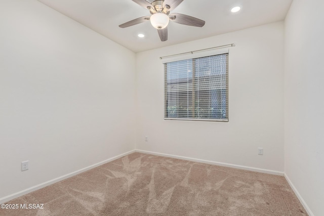 carpeted spare room with recessed lighting, ceiling fan, and baseboards